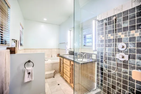 a bathroom with a granite countertop toilet sink and shower