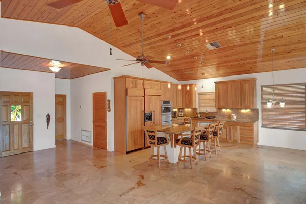 a very nice looking dining room with lots of furniture and chandelier