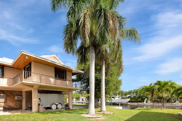 a front view of a house with yard and green space
