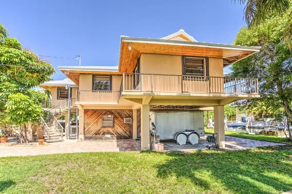 a view of a car park in front of a house