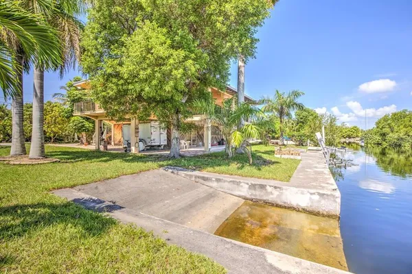 a view of a house with swimming pool and sitting area