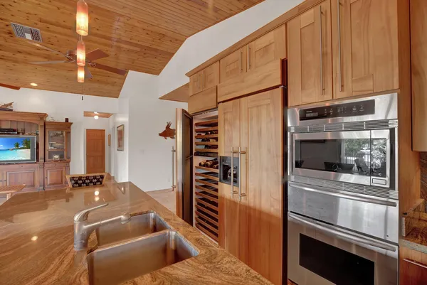 a kitchen with granite countertop stainless steel appliances and wooden cabinets