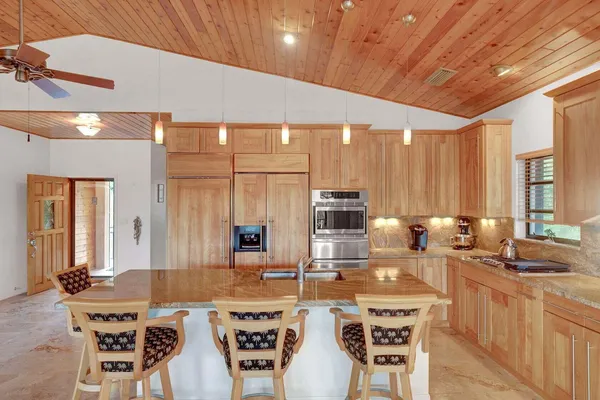 a kitchen with a table chairs stove and cabinets