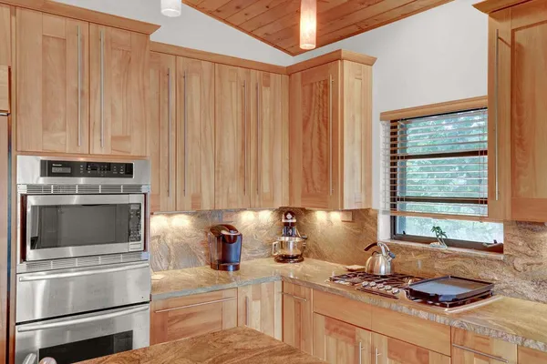 a kitchen with a stove and a refrigerator