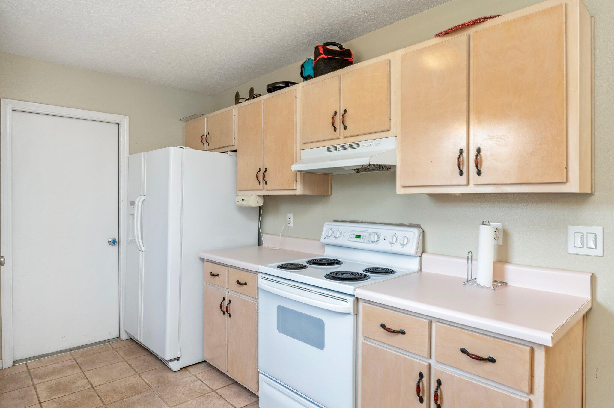 17 Flora Cove Crestview, FL 32539 - Photo 11 of 31 a kitchen with stainless steel appliances white cabinets and a refrigerator
