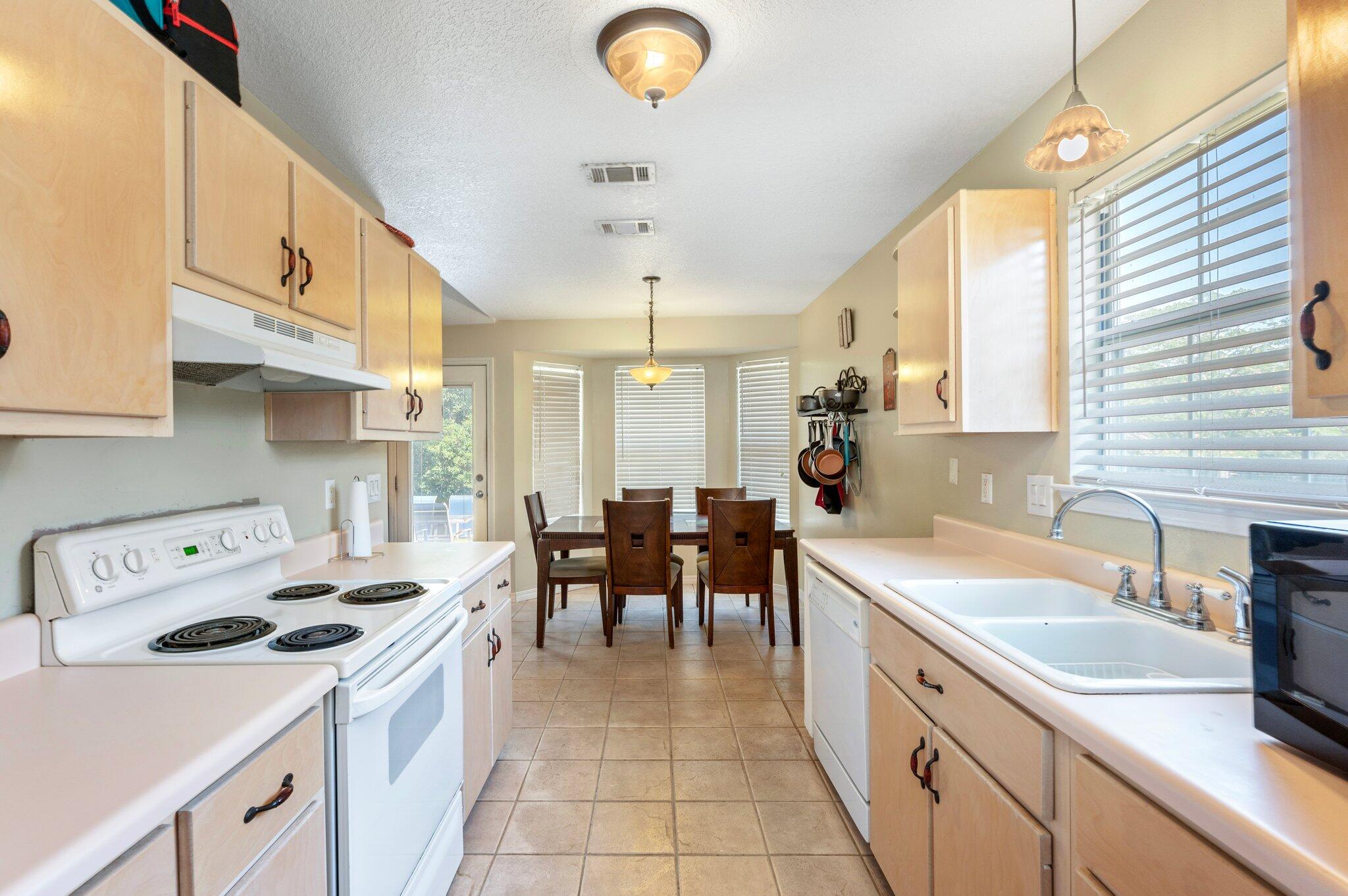 17 Flora Cove Crestview, FL 32539 - Photo 14 of 31 a kitchen with a sink a stove and chairs