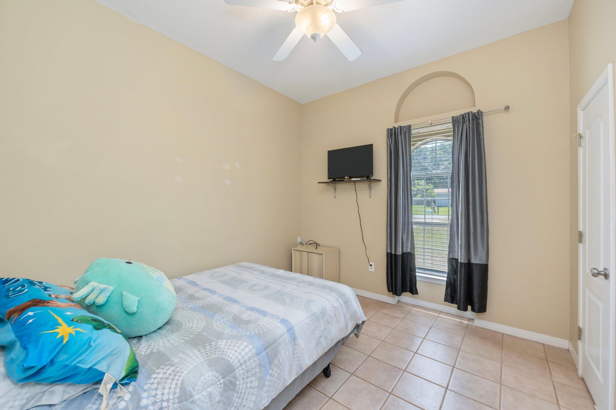 17 Flora Cove Crestview, FL 32539 - Photo 22 of 31 a bedroom with a bed and a chandelier