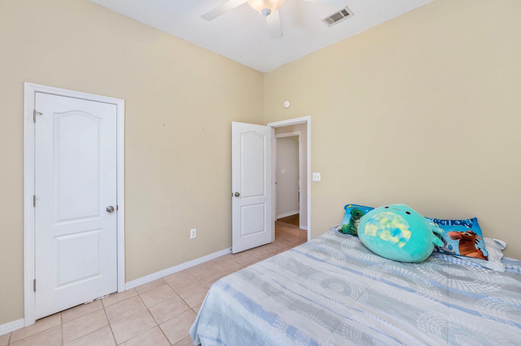 17 Flora Cove Crestview, FL 32539 - Photo 23 of 31 a bedroom with a bed and a hallway