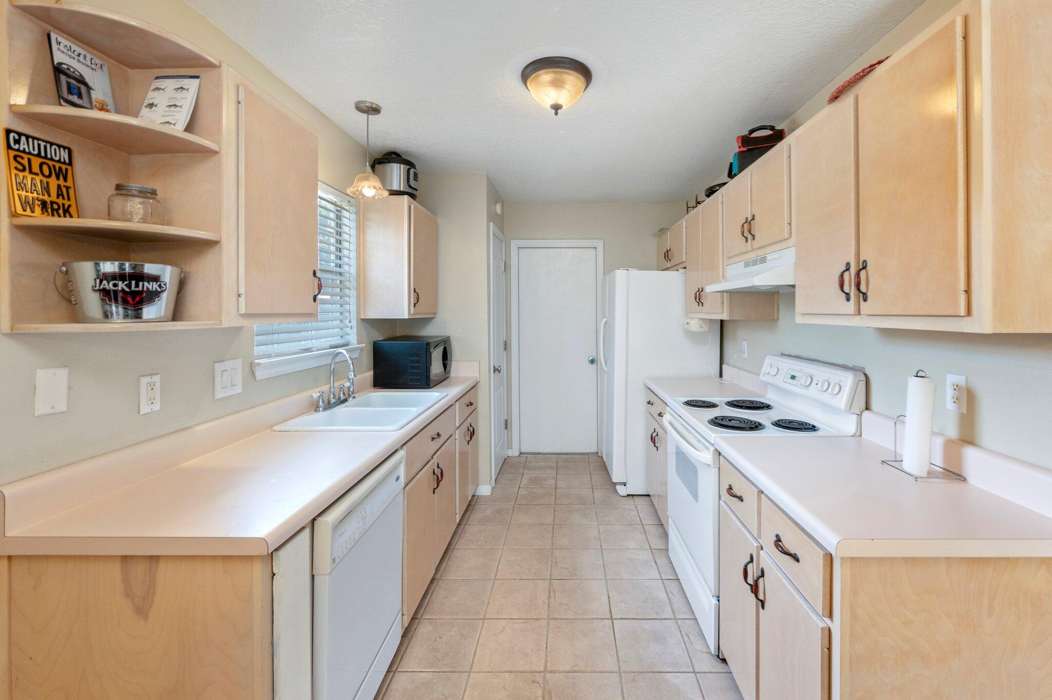 17 Flora Cove Crestview, FL 32539 - Photo 9 of 31 a kitchen with a sink a stove and cabinets