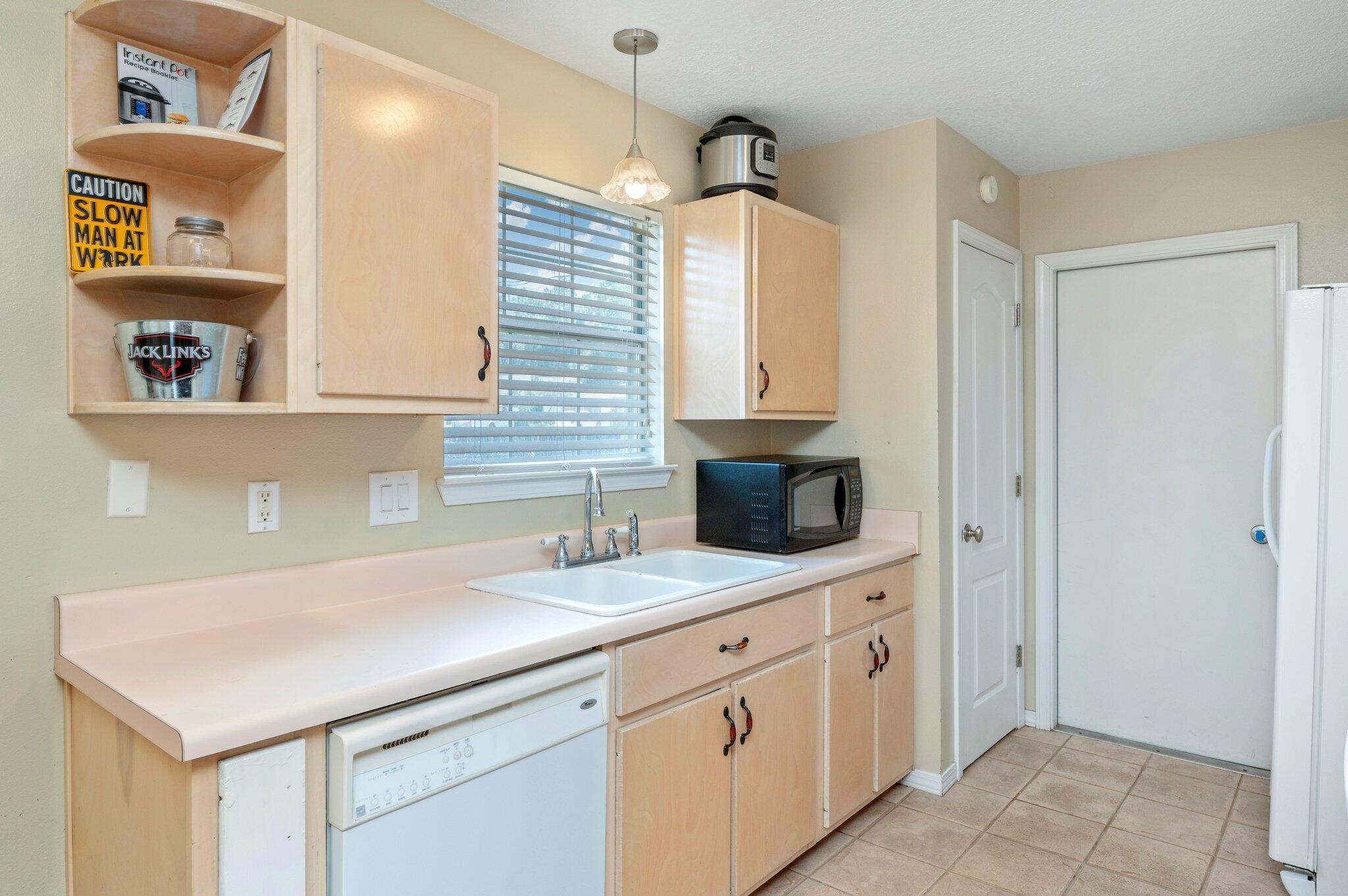 17 Flora Cove Crestview, FL 32539 - Photo 10 of 31 a kitchen with a sink and a refrigerator