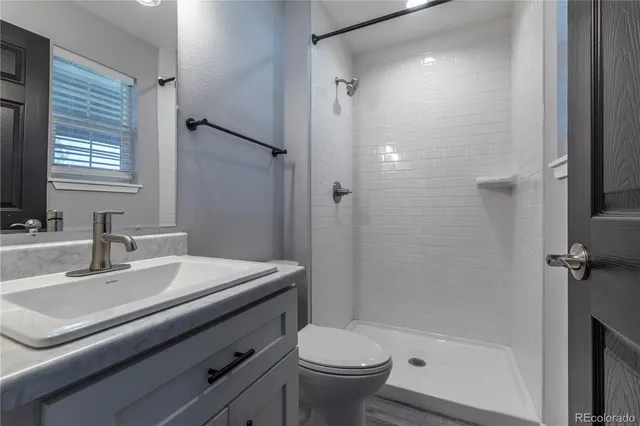 a bathroom with a sink toilet and shower