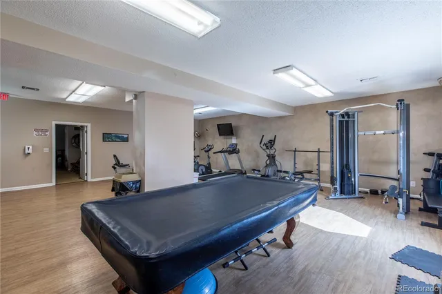 a room with pool table and windows