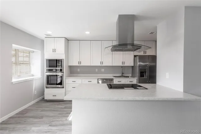 a kitchen with stainless steel appliances a stove and more cabinets