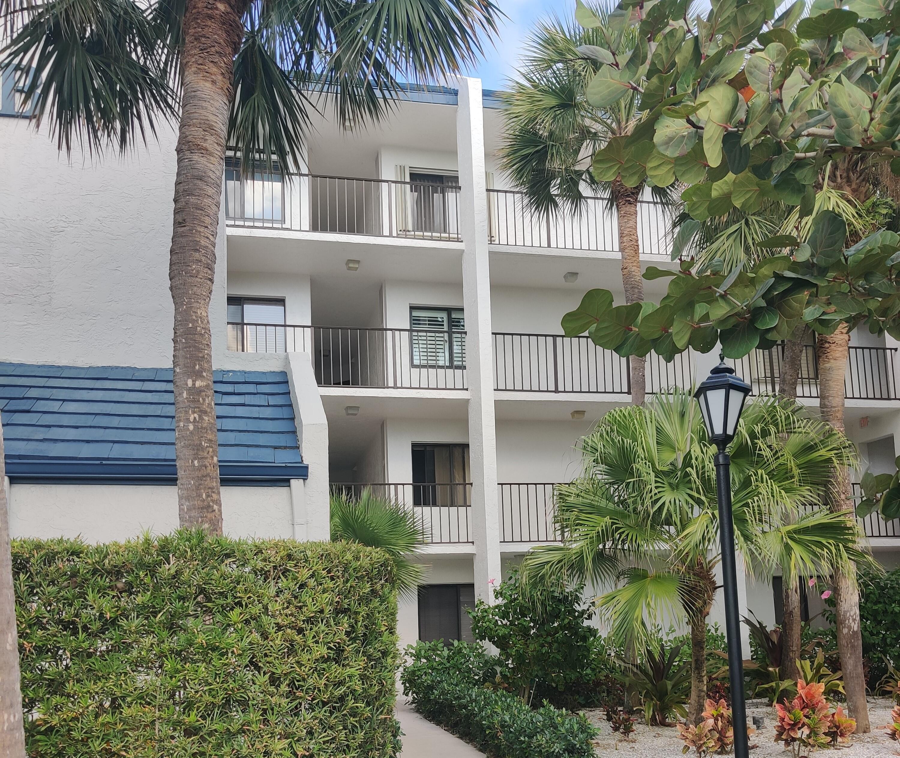 1605 Highway 1, Unit B404 Jupiter, FL 33477 - Photo 16 of 17 front view of house with a palm plants