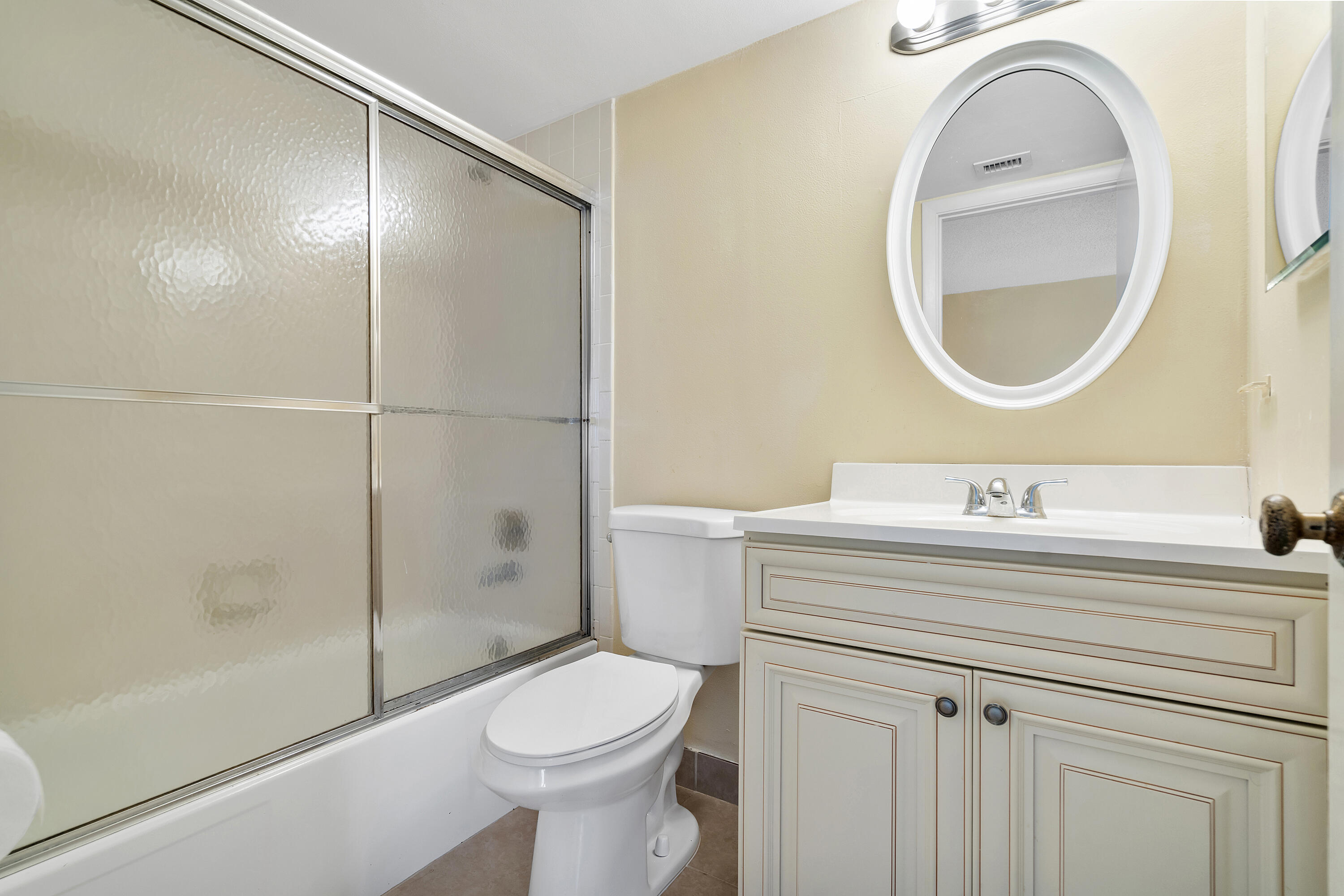 1605 Highway 1, Unit B404 Jupiter, FL 33477 - Photo 9 of 17 a bathroom with a sink a toilet and a mirror