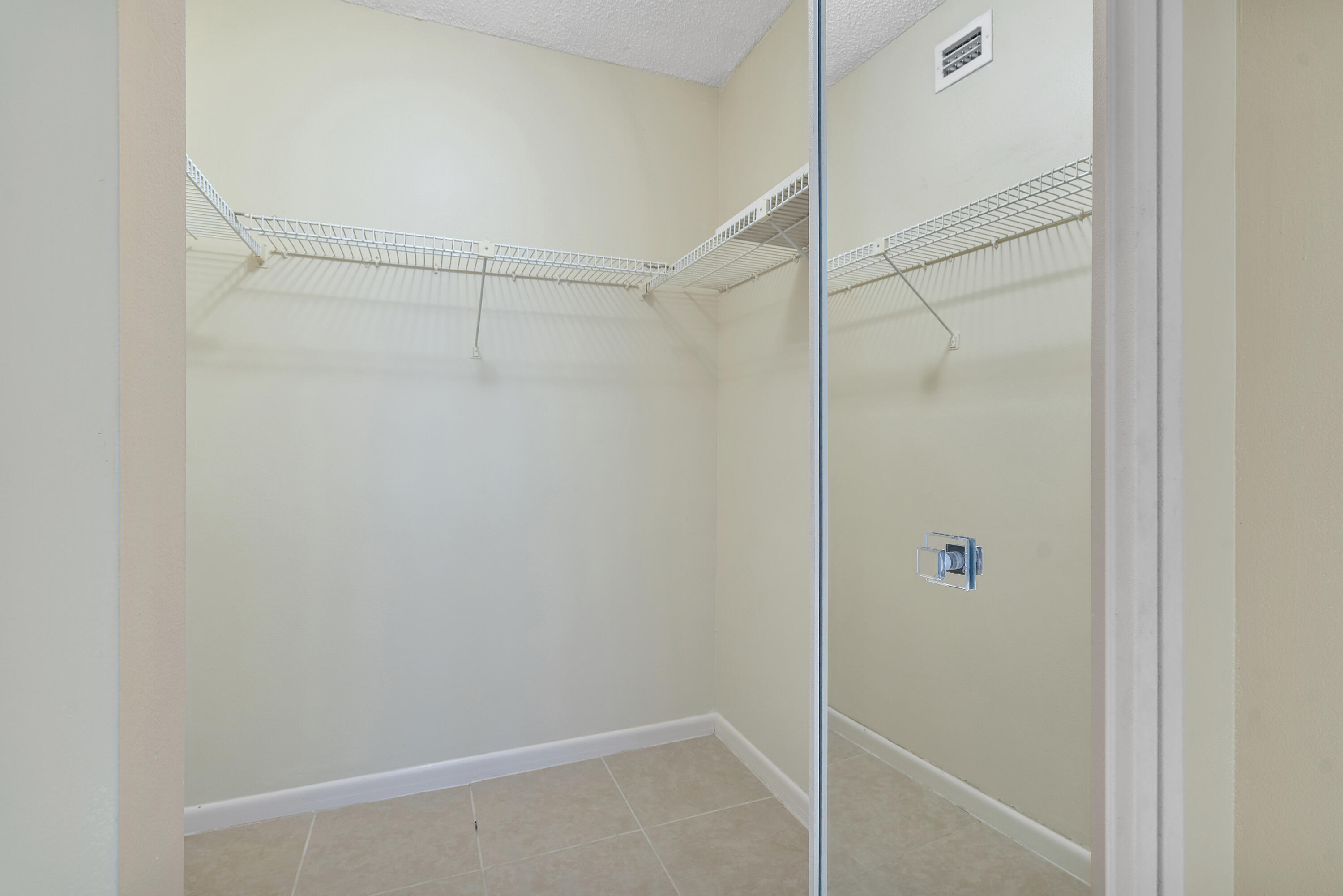 1605 Highway 1, Unit B404 Jupiter, FL 33477 - Photo 10 of 17 a bathroom with a glass shower door