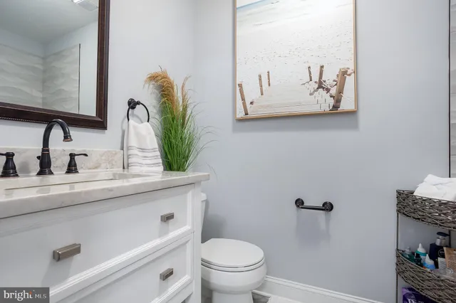 a bathroom with a toilet sink and mirror