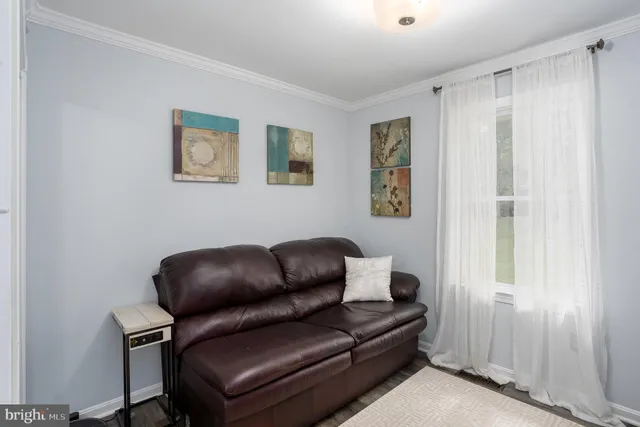 a blue couch sitting next to a window