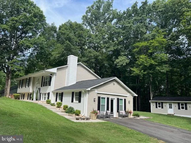 a front view of a house with a yard table and chairs