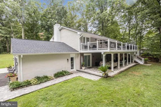 a view of a house with a yard and sitting area