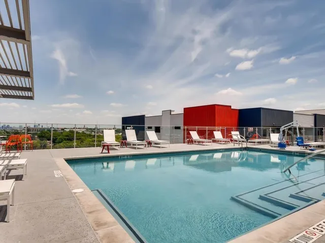 a view of a swimming pool with outdoor seating