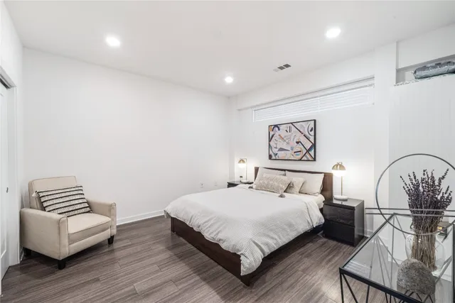 a bedroom with a bed and a couch