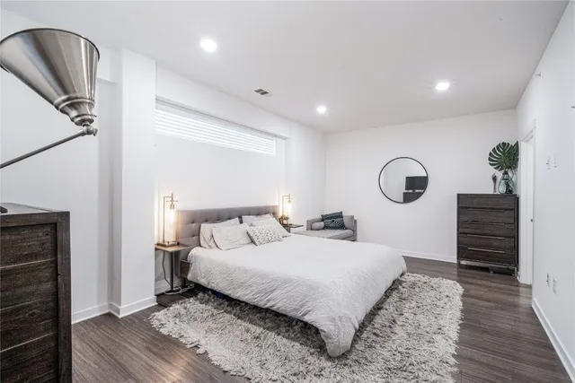 a bedroom with a bed and a dresser