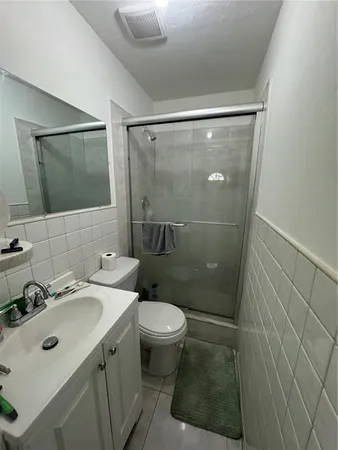 a bathroom with a sink mirror vanity and toilet