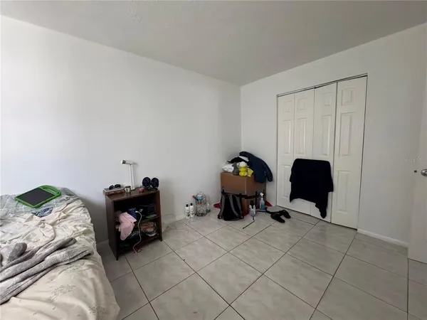 a bedroom with a bed and a chair