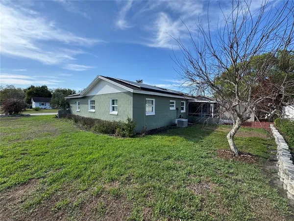 a view of a house with a backyard