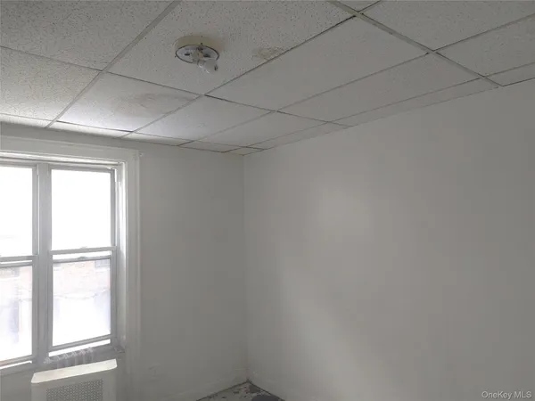 a view of a livingroom with an empty space and a window