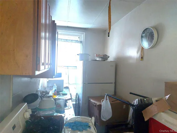 a kitchen with a refrigerator and a window