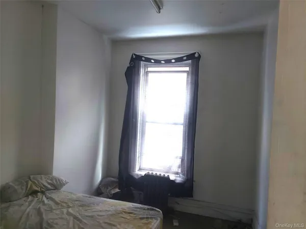 a bedroom with a bed and a window