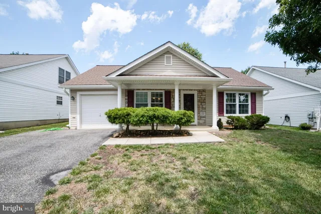 a view of a house with next to a yard