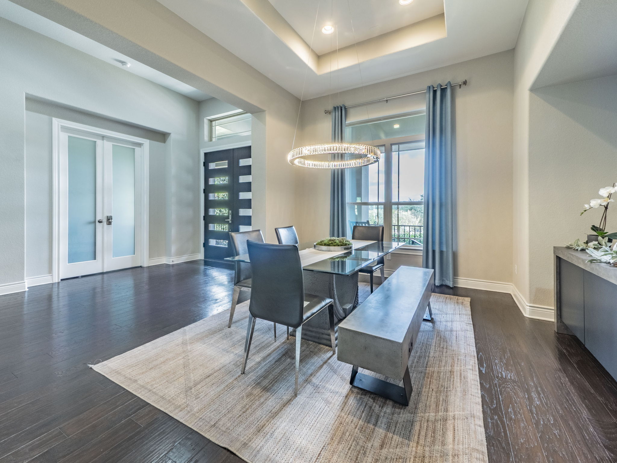 205 Standing Oak Drive Georgetown, TX 78633 - Photo 11 of 40 Dining area with french doors, a tray ceiling, dark wood-style floors, recessed lighting, and a chandelier