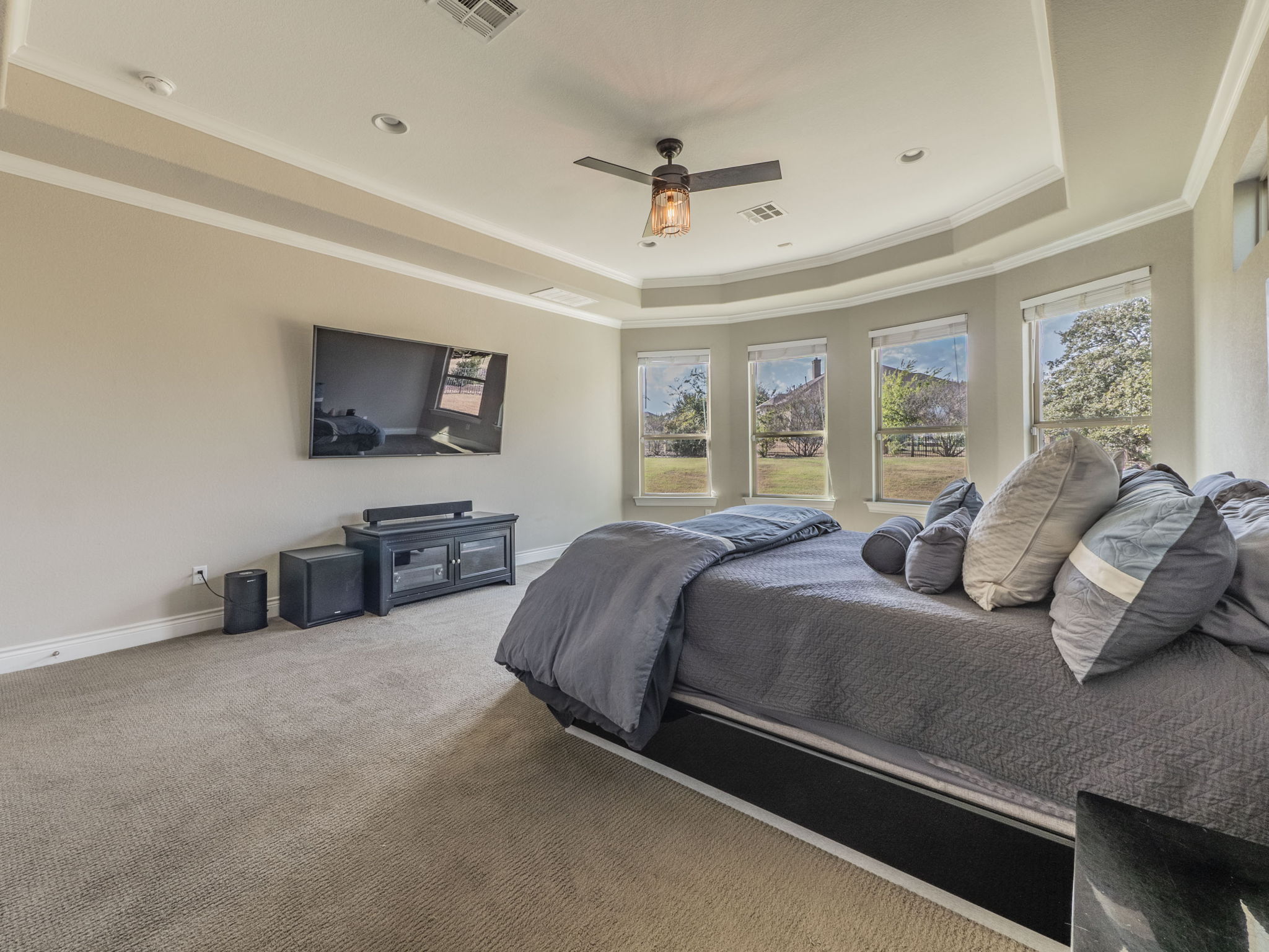 205 Standing Oak Drive Georgetown, TX 78633 - Photo 14 of 40 Bedroom featuring a raised ceiling, carpet, ornamental molding, and ceiling fan