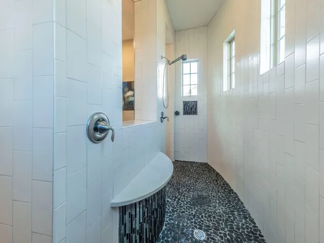 a spacious bathroom with a bathtub sink and mirror
