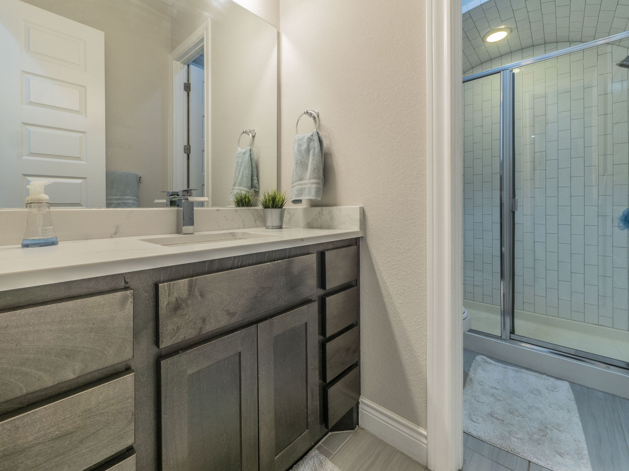 205 Standing Oak Drive Georgetown, TX 78633 - Photo 23 of 40 Full bath featuring a shower stall, a textured wall, and vanity