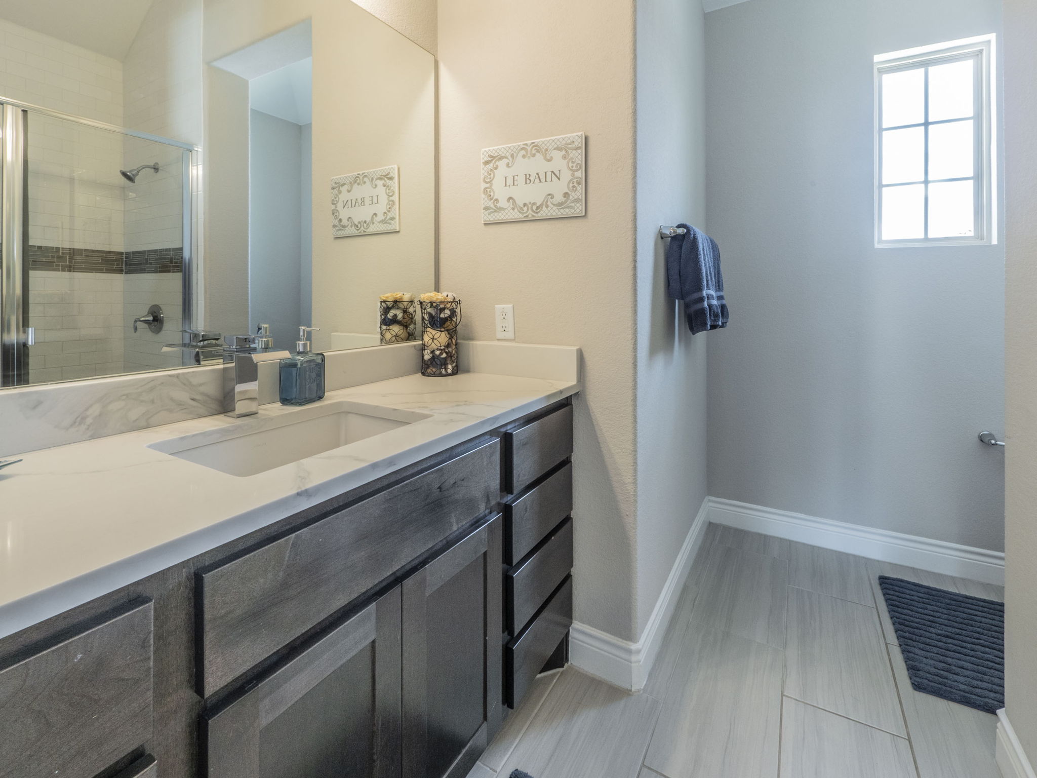 205 Standing Oak Drive Georgetown, TX 78633 - Photo 26 of 40 Bathroom featuring vanity, a shower stall, and light tile patterned floors
