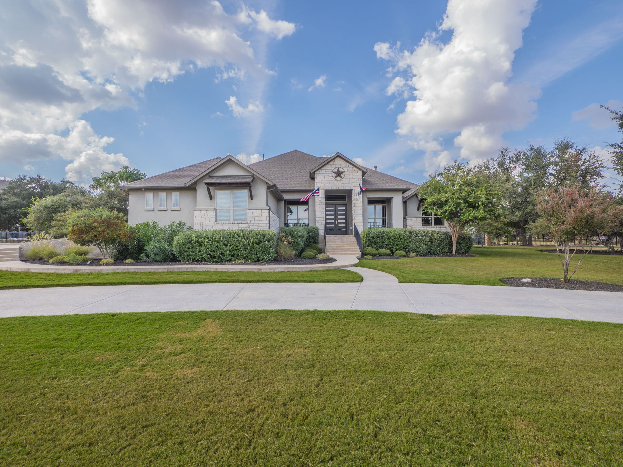 205 Standing Oak Drive Georgetown, TX 78633 - Photo 30 of 40 View of front of house featuring a front yard, stone siding, and stucco siding