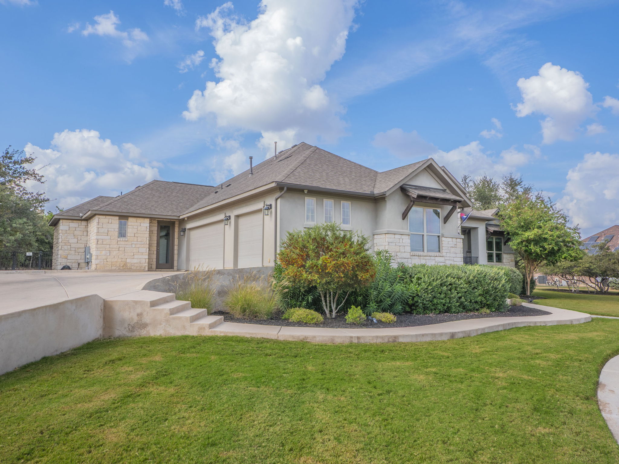 205 Standing Oak Drive Georgetown, TX 78633 - Photo 31 of 40 View of front of property with stone siding, a front lawn, and stucco siding