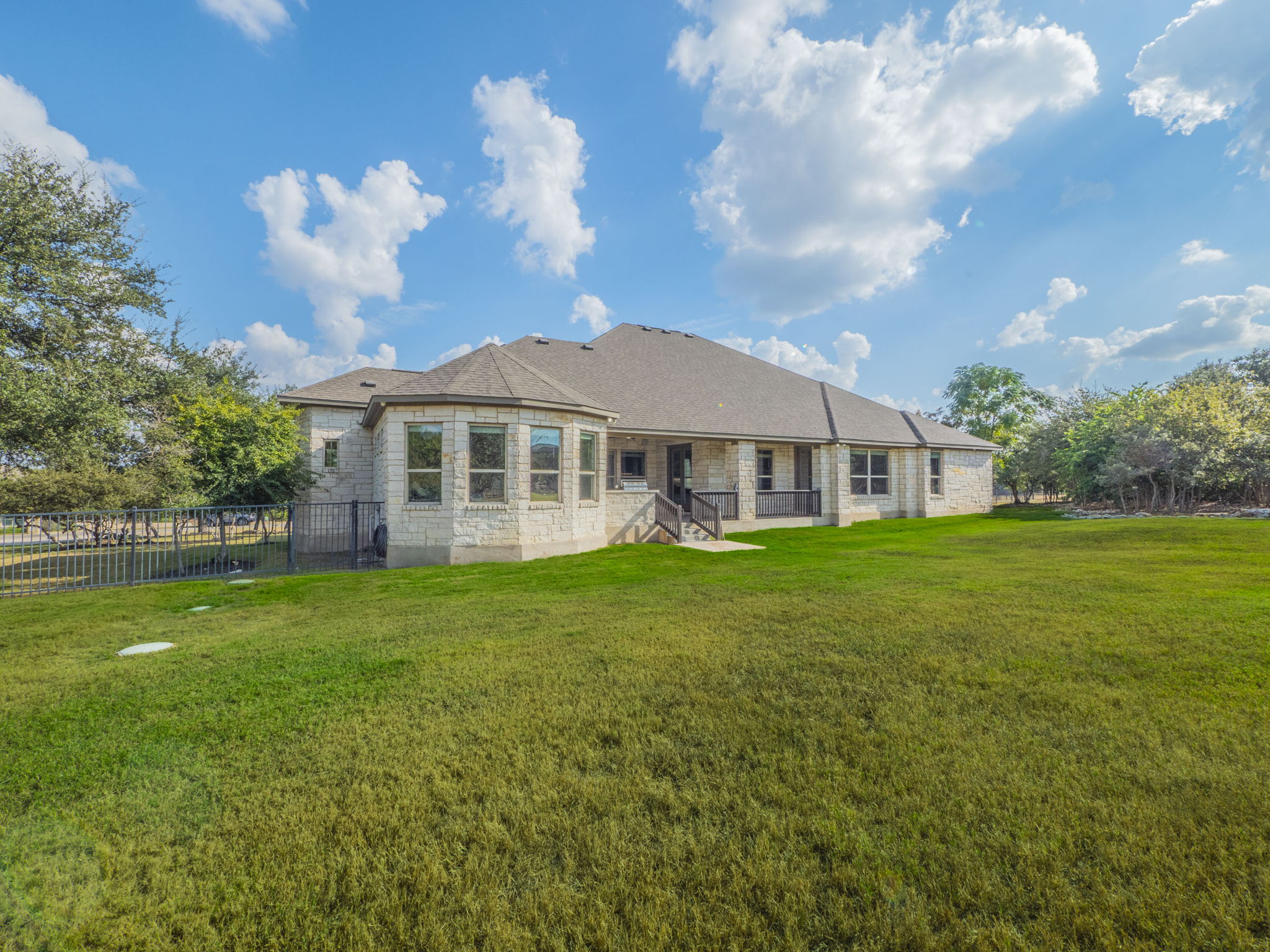 205 Standing Oak Drive Georgetown, TX 78633 - Photo 33 of 40 Back of property with stone siding and a patio area