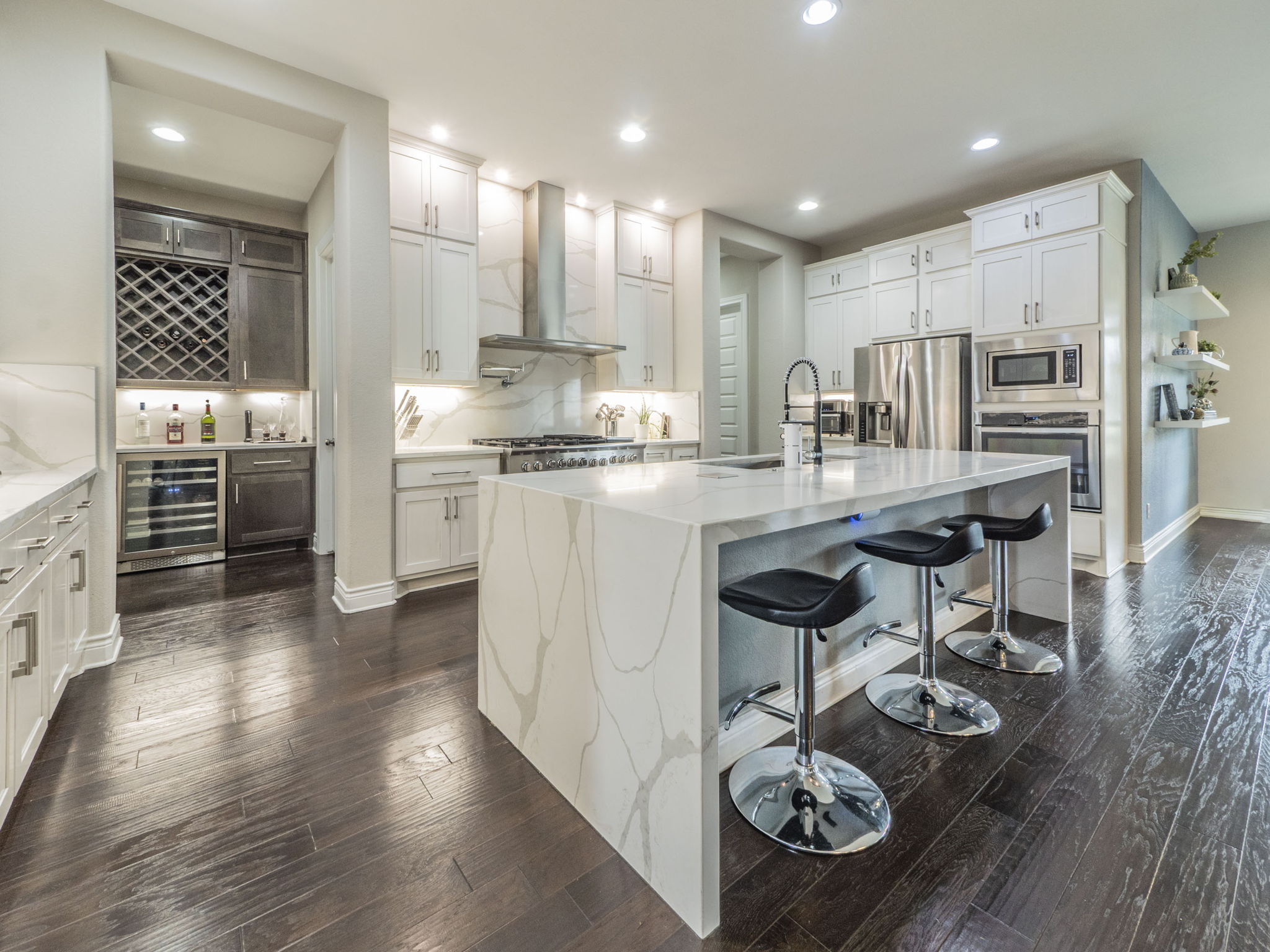 205 Standing Oak Drive Georgetown, TX 78633 - Photo 7 of 40 Kitchen featuring a breakfast bar, light stone countertops, backsplash, white cabinets, and appliances with stainless steel finishes