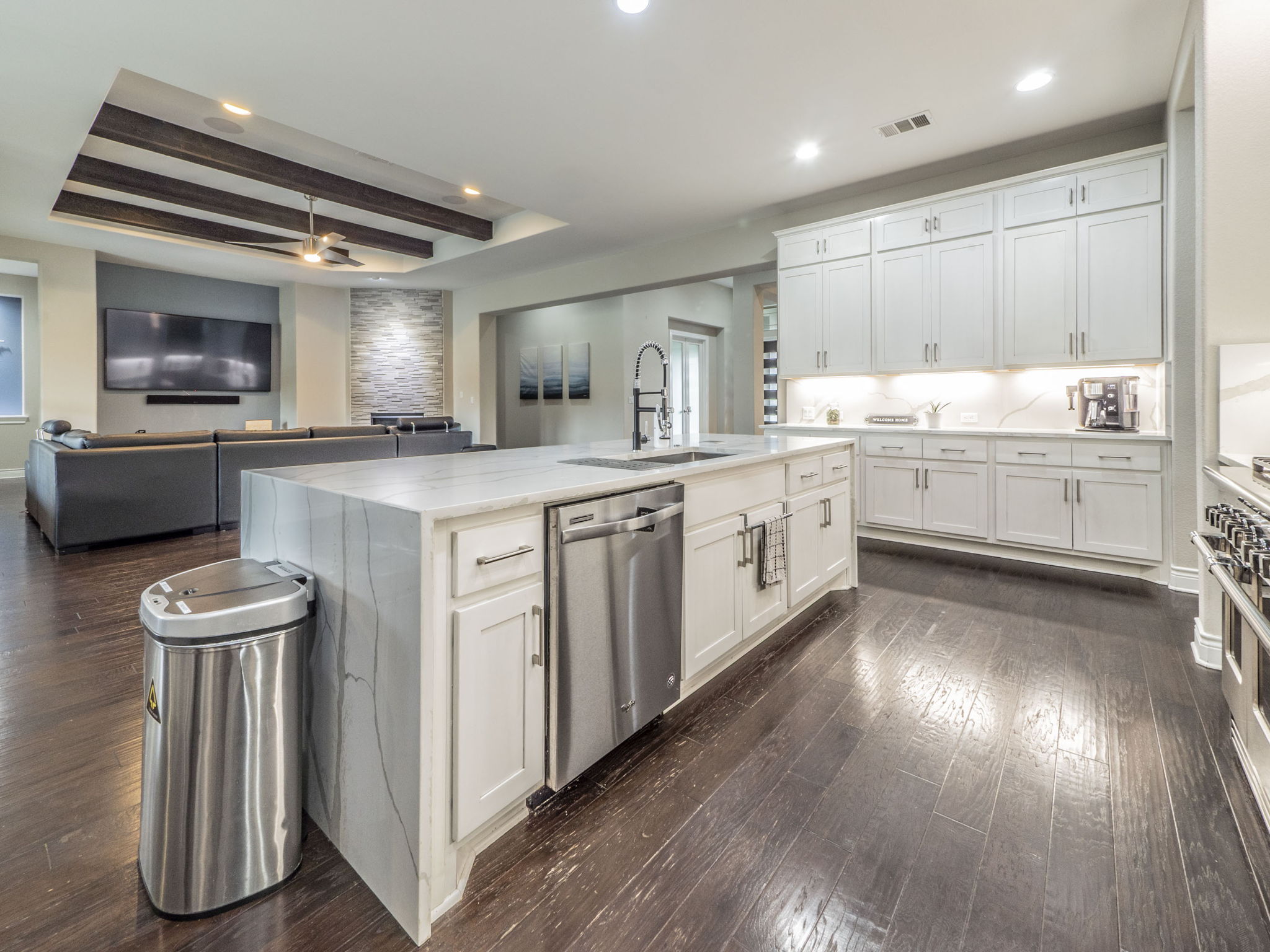 205 Standing Oak Drive Georgetown, TX 78633 - Photo 40 of 40 Kitchen with open floor plan, white cabinetry, a tray ceiling, recessed lighting, and beamed ceiling