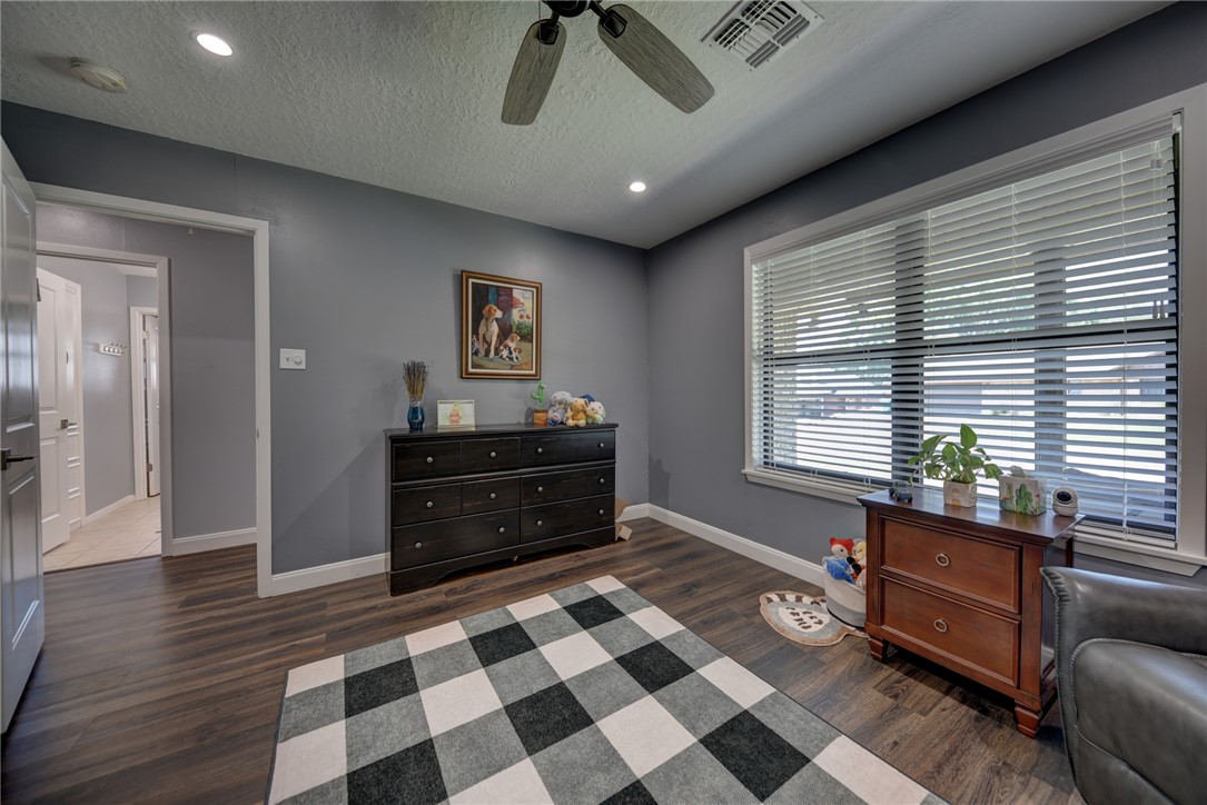 1600 Pecan Street Brenham, TX 77833 - Photo 18 of 33 Bedroom with natural lighting, ceiling fan, baseboards, a textured ceiling, and recessed lighting
