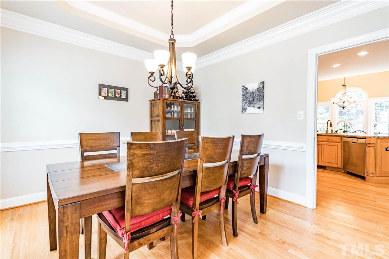 8108 Fallston Court Raleigh, NC 27613 - Photo 13 of 23 a dining room with furniture and chandelier