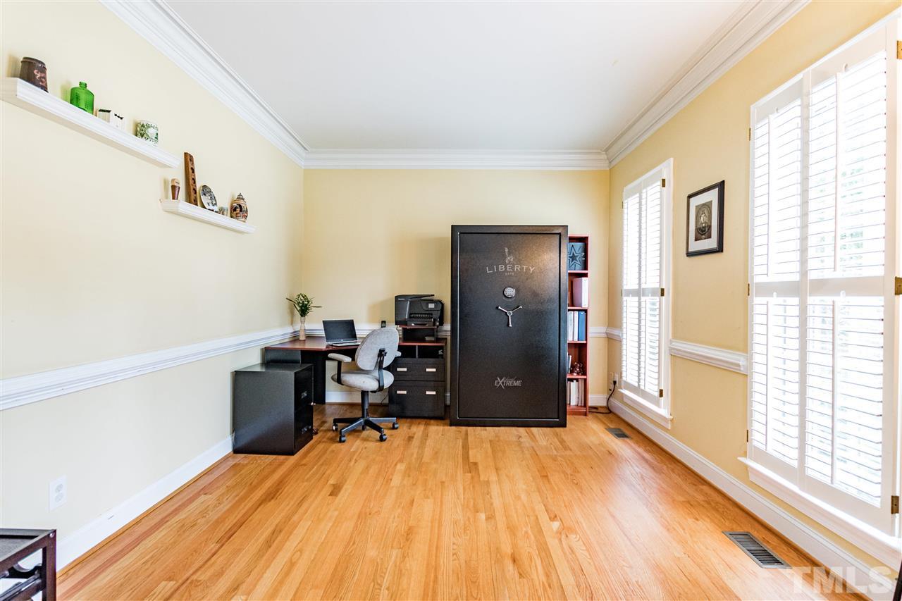 8108 Fallston Court Raleigh, NC 27613 - Photo 14 of 23 a bed room with a bed and a table