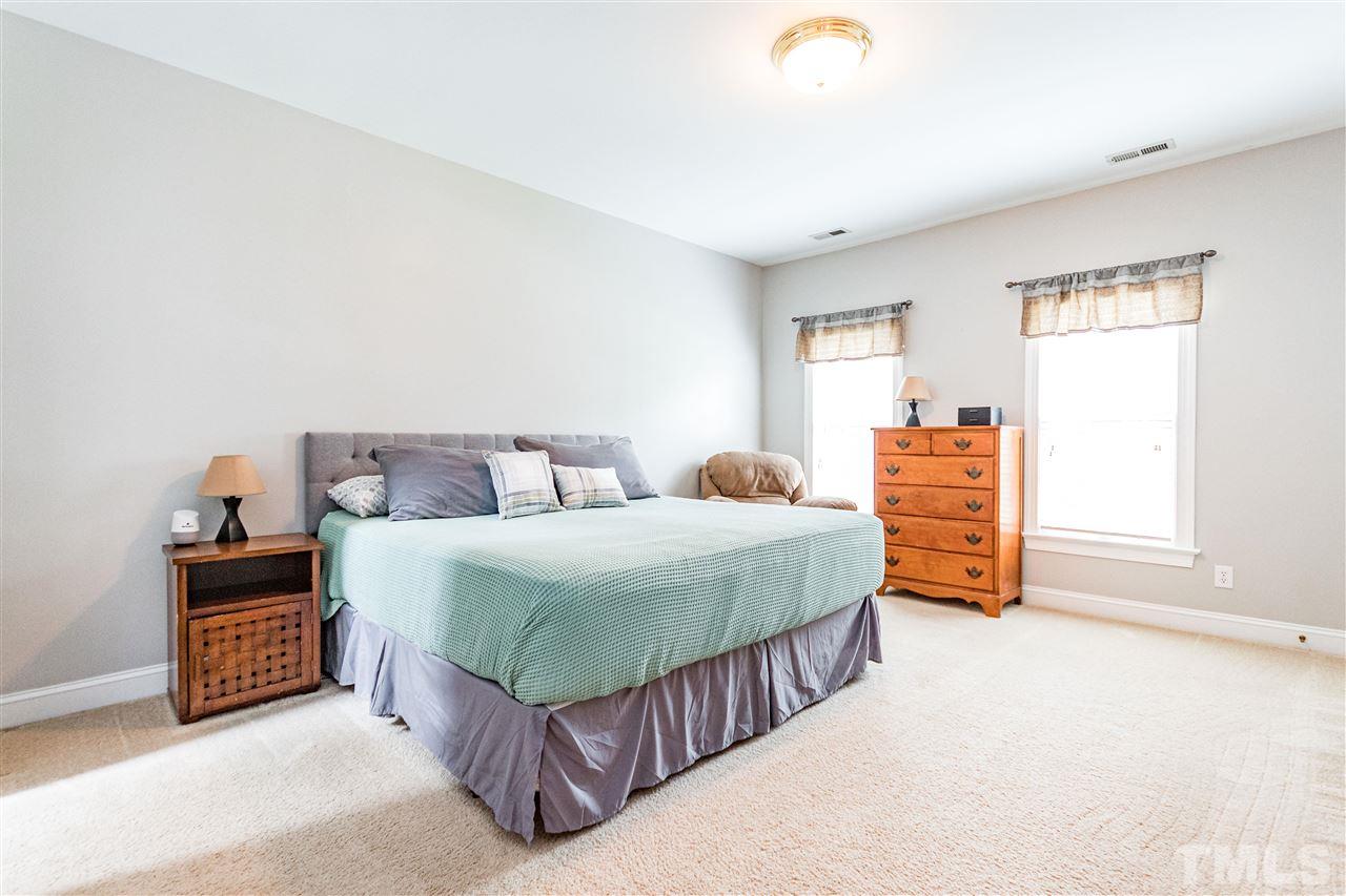 8108 Fallston Court Raleigh, NC 27613 - Photo 15 of 23 a bedroom with a bed and a window