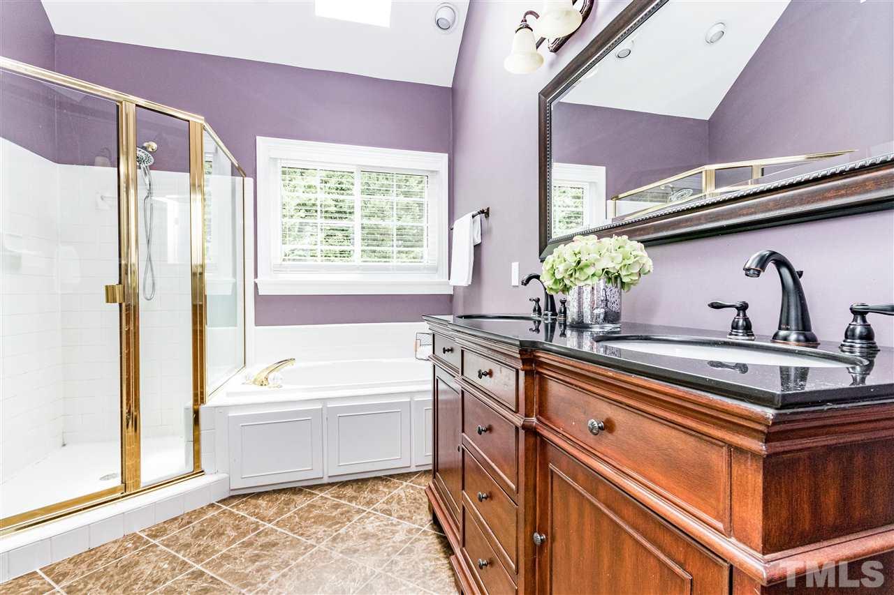 8108 Fallston Court Raleigh, NC 27613 - Photo 16 of 23 a bathroom with a tub sink and wooden floor