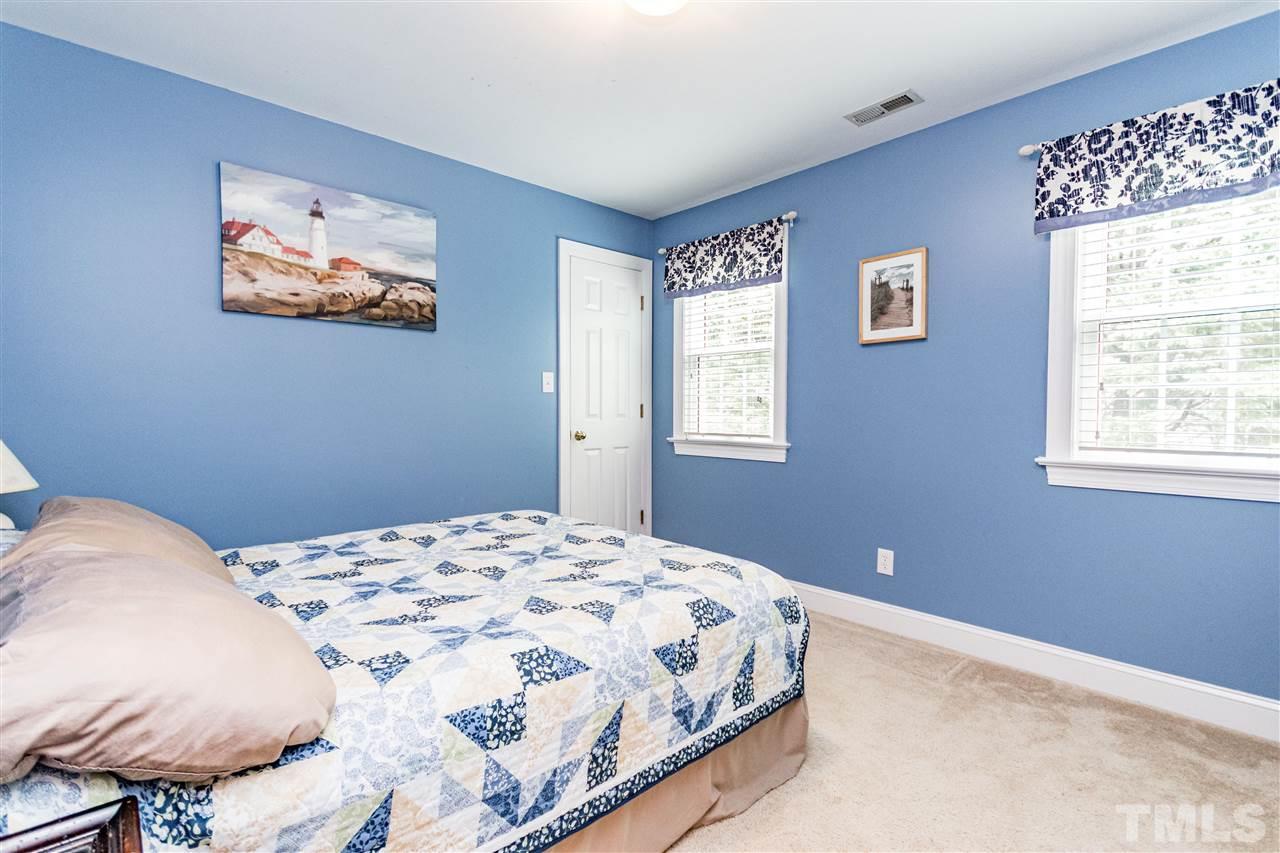 8108 Fallston Court Raleigh, NC 27613 - Photo 19 of 23 a bedroom with a bed and a window